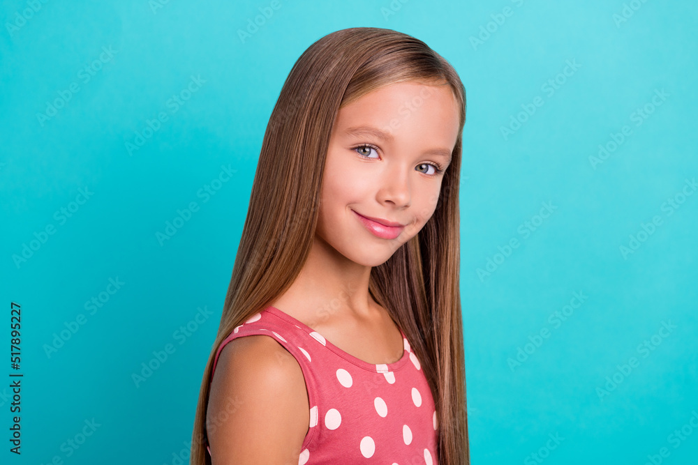 Photo of sweet adorable little lady dressed dotted sarafan smiling isolated teal color background Photo of sweet adorable little lady dressed dotted sarafan smiling isolated teal color background