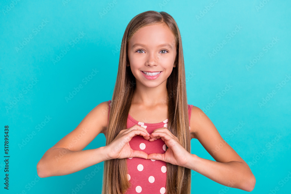 Photo of sweet shiny small girl wear pink dress showing arms heart isolated turquoise color background