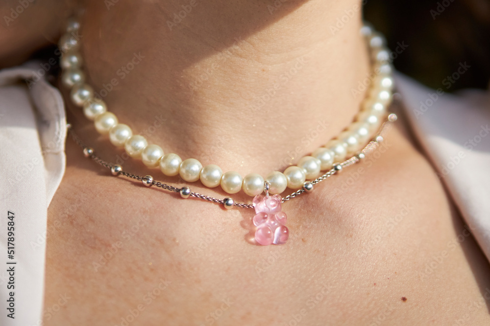 Modern jewelry made of beads and beads on the girl's neck. multi-colored jewelry made of beads and beads Modern jewelry made of beads and beads on the girl's neck. multi-colored jewelry made of beads and beads