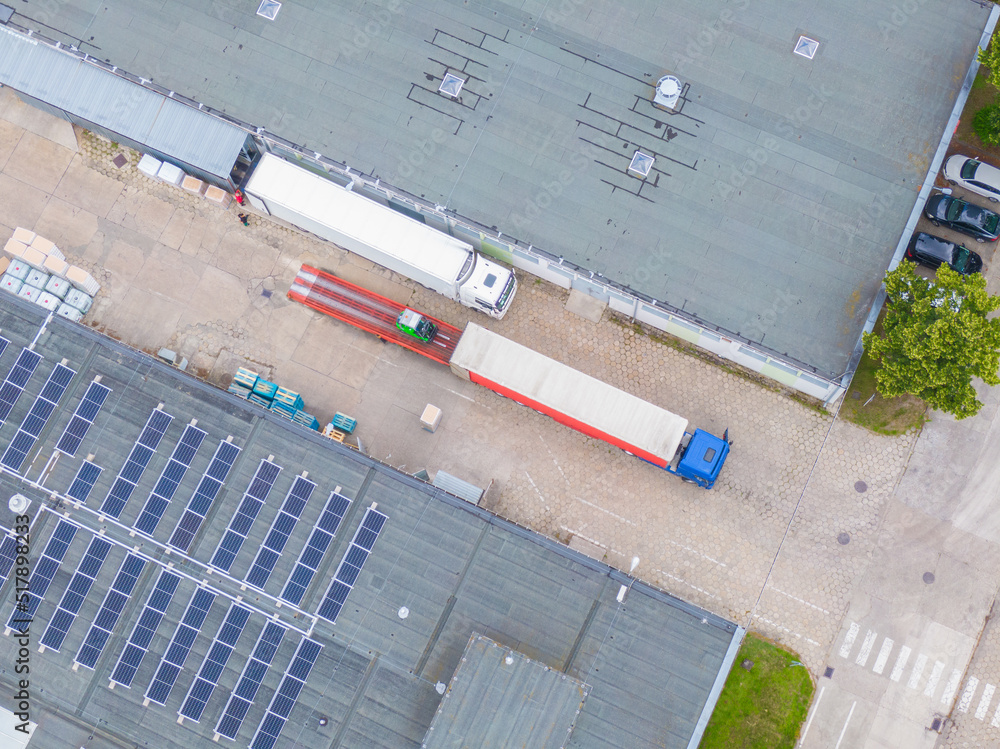 Aerial Shot of Industrial Warehouse/ Storage Building/ Loading. logistics center from above. Aerial view of industrial buildings and equipment machines Aerial Shot of Industrial Warehouse/ Storage Building/ Loading. logistics center from above. Aerial view of industrial buildings and equipment machines