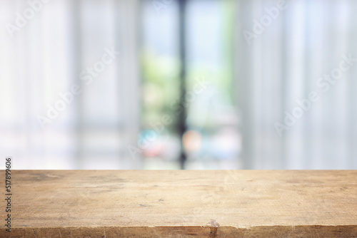 Wooden table and blurred window background, bright morning light. Product display or mock up