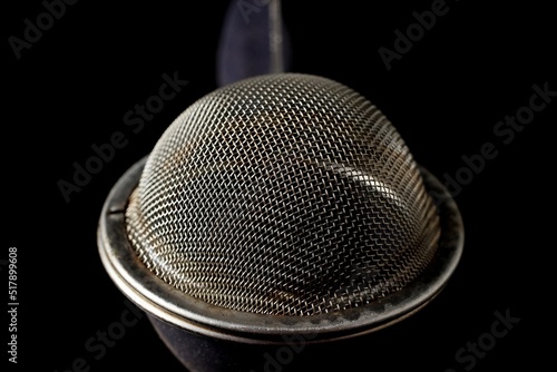 metal strainer for brewing loose tea close-up on a black background photo