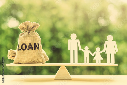Family loan agreement, financial concept : Loan bag, a family, father and mother with children on a balance scale, depicting lending money to a family and protecting them during divorce or separation. photo