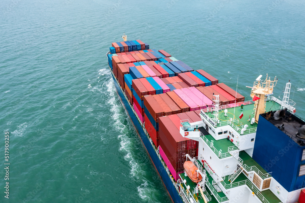 aerial back view of container ship carrying cargo container import export internatioonal and worldwide, business and industry goods logistic transportation by container ship in open sea,