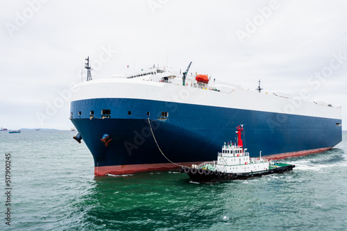 Roll-on Roll-of  ship loading new cars line up . Automotive container carriers floating in sea, business services import export international by Roll-on Roll-of ship large in the Ocean freight,
