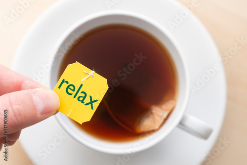 Top down view of cup of tea with the word 'relax'
