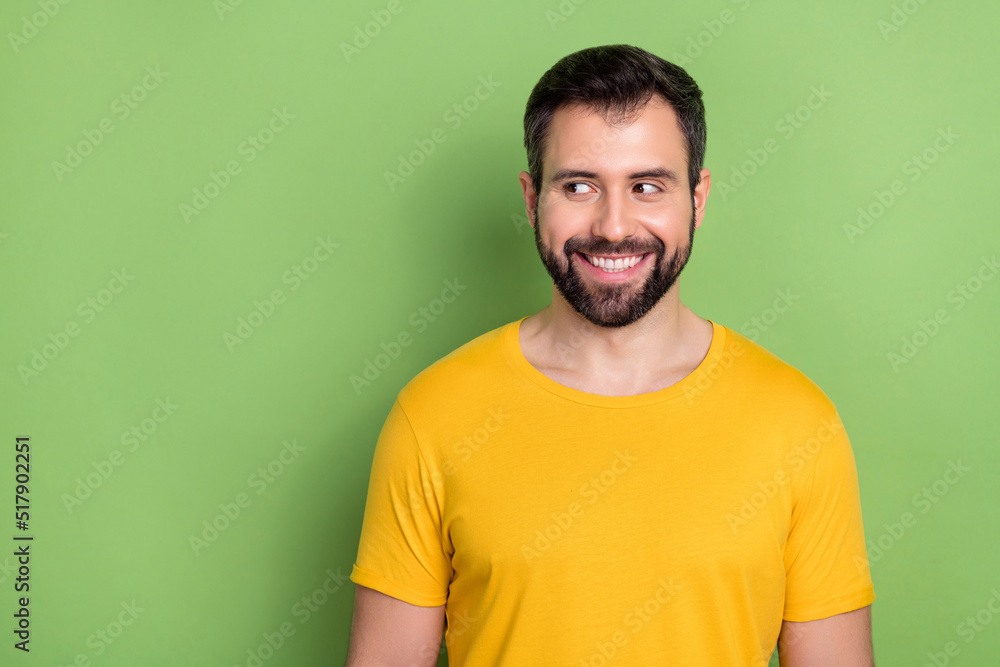 Portrait of cheerful satisfied person beaming smile look interested empty space isolated on green color background Portrait of cheerful satisfied person beaming smile look interested empty space isolated on green color background
