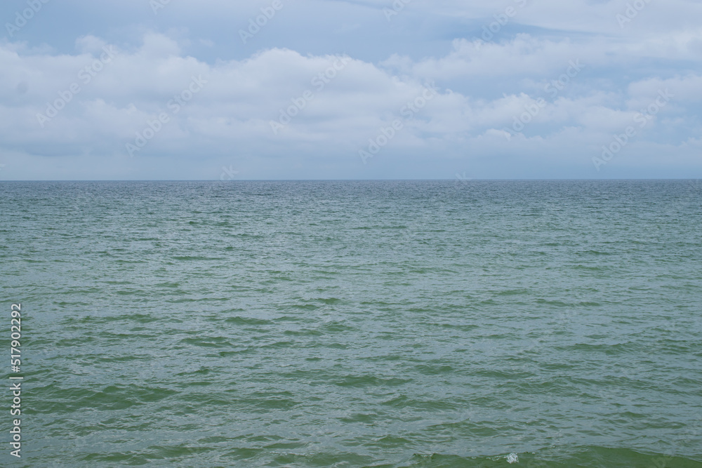Calm and peaceful nothern sea in a cloudy weather. Baltic sea summer background