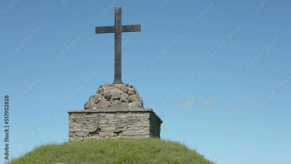 A tombstone on top of the hill in the cemetery on a hot sunny day in Estonia A tombstone on top of the hill in the cemetery on a hot sunny day in Estonia