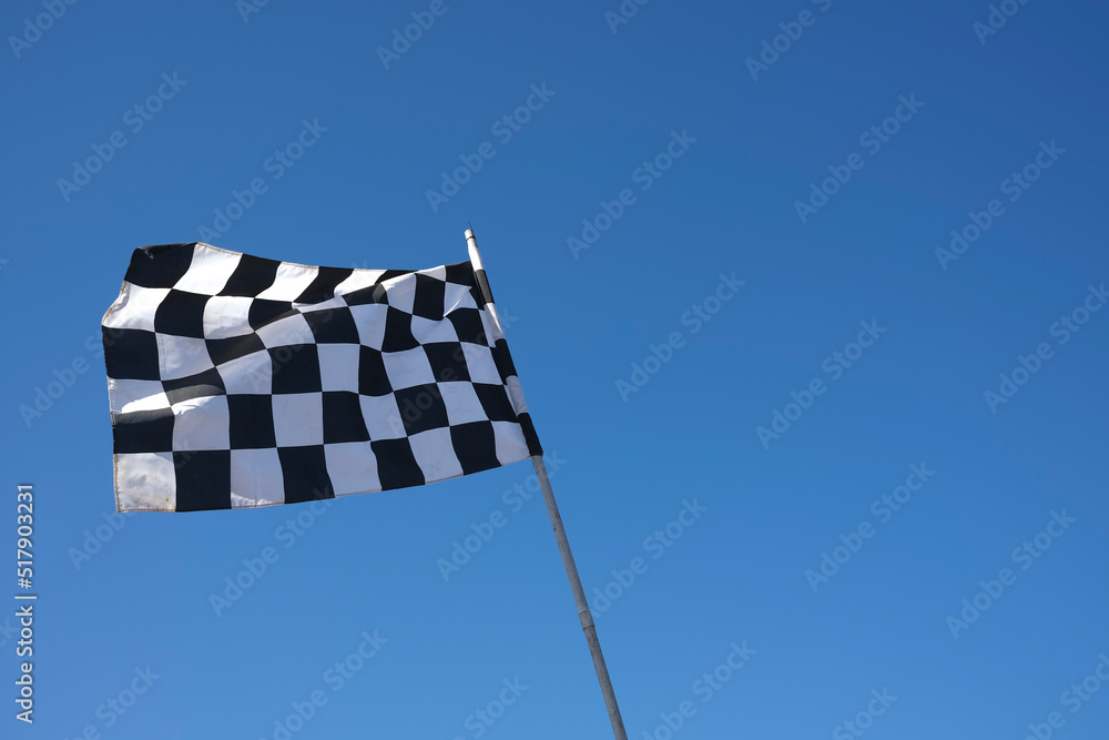 chequered flag against blue sky