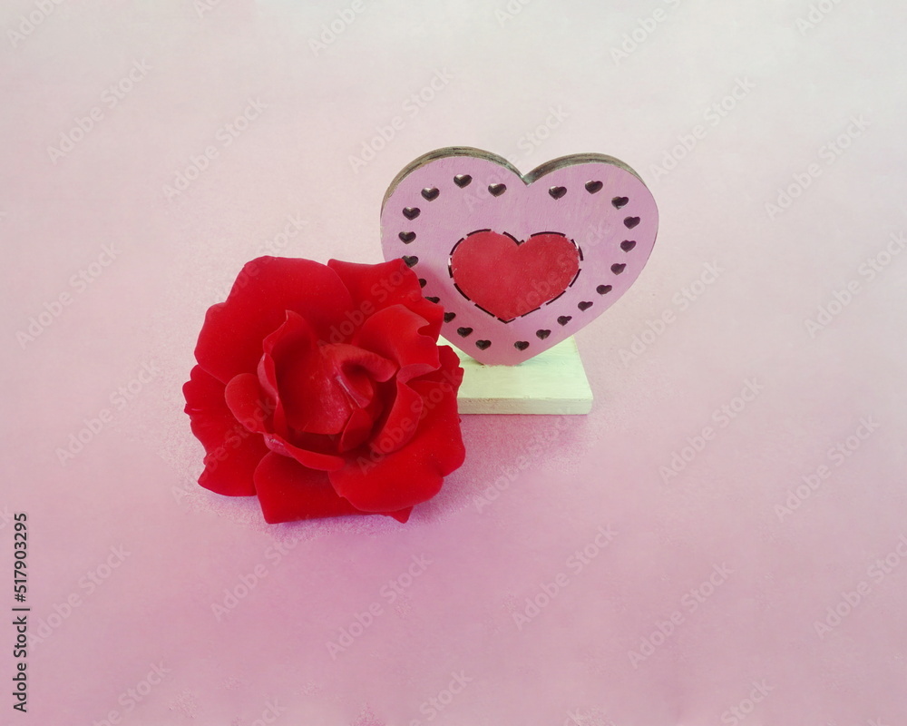 Red Rose with Pink and Red Heart Wooden Cutout on Pink Background