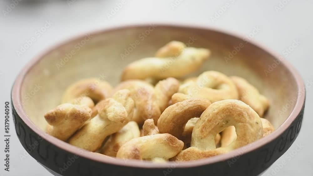 Serving taralli with oregano in a bowl. Serving taralli with oregano in a bowl.