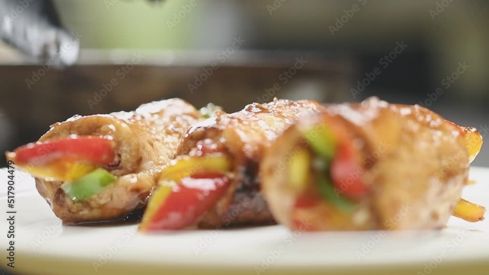 Serving of juicy teriyaki pork rolls with bell peppers. Serving of juicy teriyaki pork rolls with bell peppers.