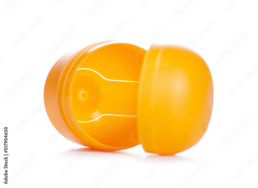Yellow egg toy capsule on white background isolation