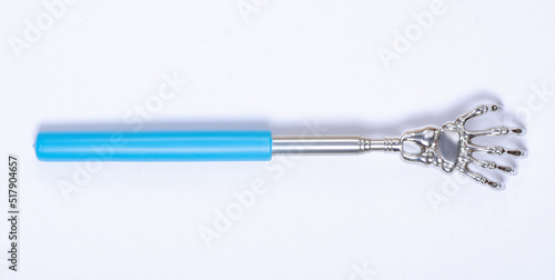 Metal back scratcher on white background isolation, top view