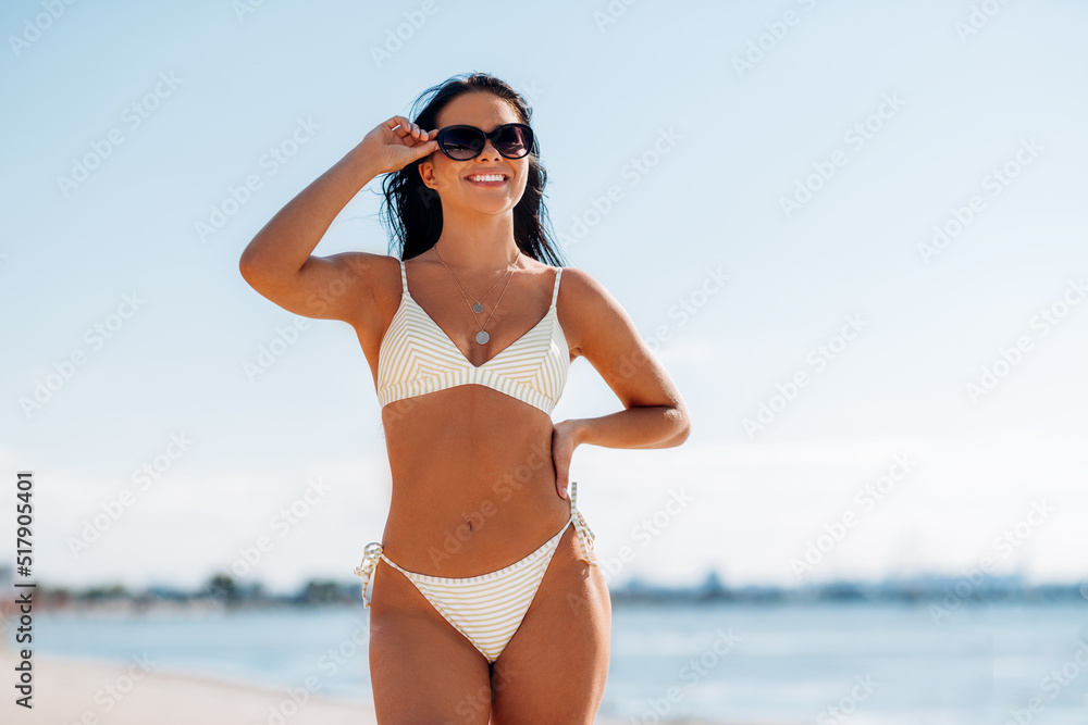 people, summer and swimwear concept - happy smiling young woman in bikini swimsuit on beach people, summer and swimwear concept - happy smiling young woman in bikini swimsuit on beach