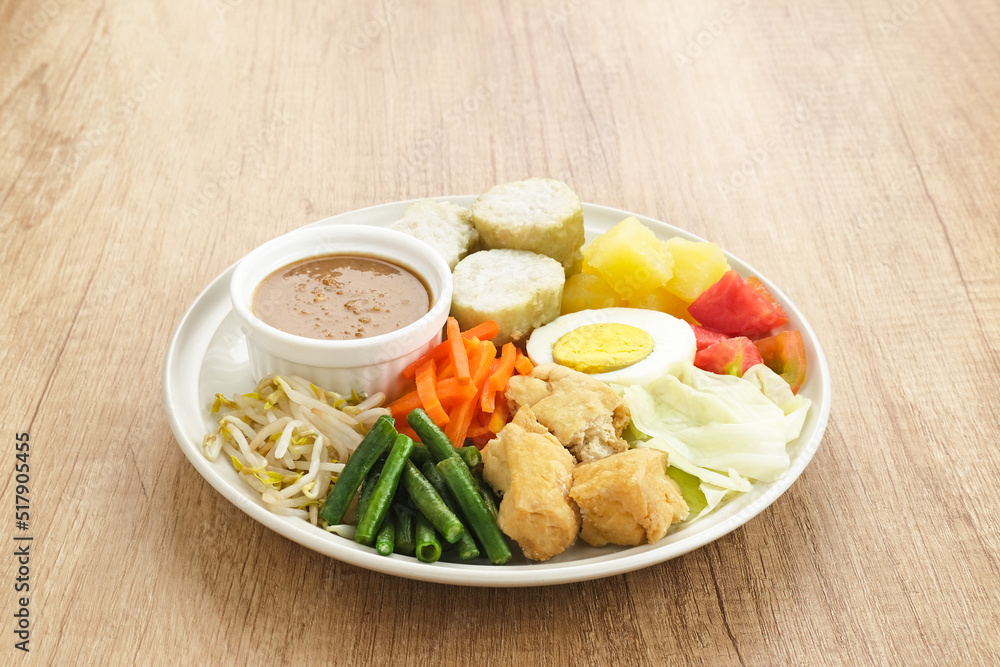 Gado Gado, Indonesian traditional vegetable salad with peanut sauce, rice cake, tofu and egg
Gado Gado, Indonesian traditional vegetable salad with peanut sauce, rice cake, tofu and egg
