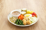 Gado Gado, Indonesian traditional vegetable salad with peanut sauce, rice cake, tofu and egg
