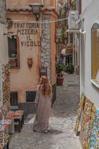 Woman wandering in Sicilian streets of Castelmola. photo