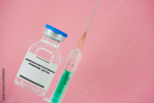 Adrenocorticotropic hormone (ACTH). Test tube with artificial hormone on pink background Adrenocorticotropic hormone (ACTH) photo