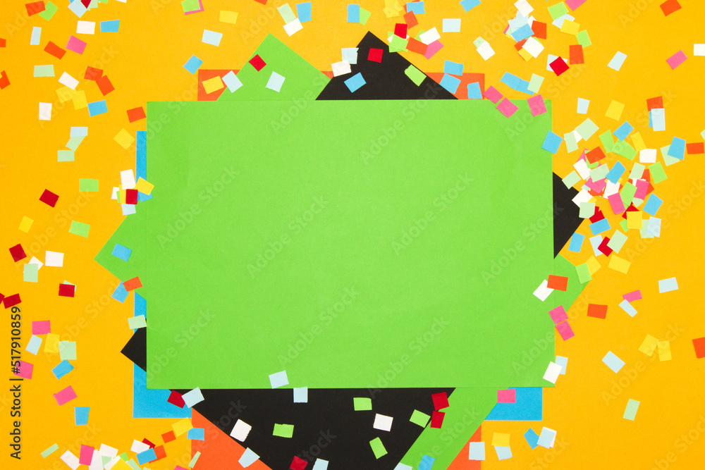 yellow background with colorful chopped paper on it green paper as copy space, creative art modern design
