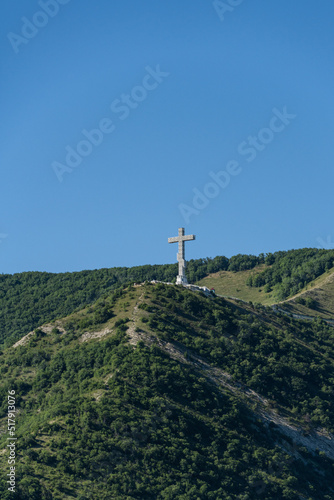 Worship cross 43 meters high on Markotkh Ridge.in Gelendzhik. Close-up. Caucasian mountains covered with forest. Landmark of city, towering over bay. Gelendzhik, Russia02 July 2022