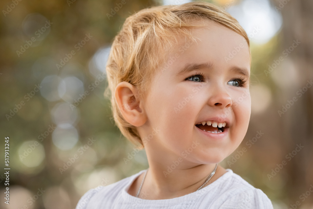 Portrait of happy baby girl looking away outdoors. Portrait of happy baby girl looking away outdoors.