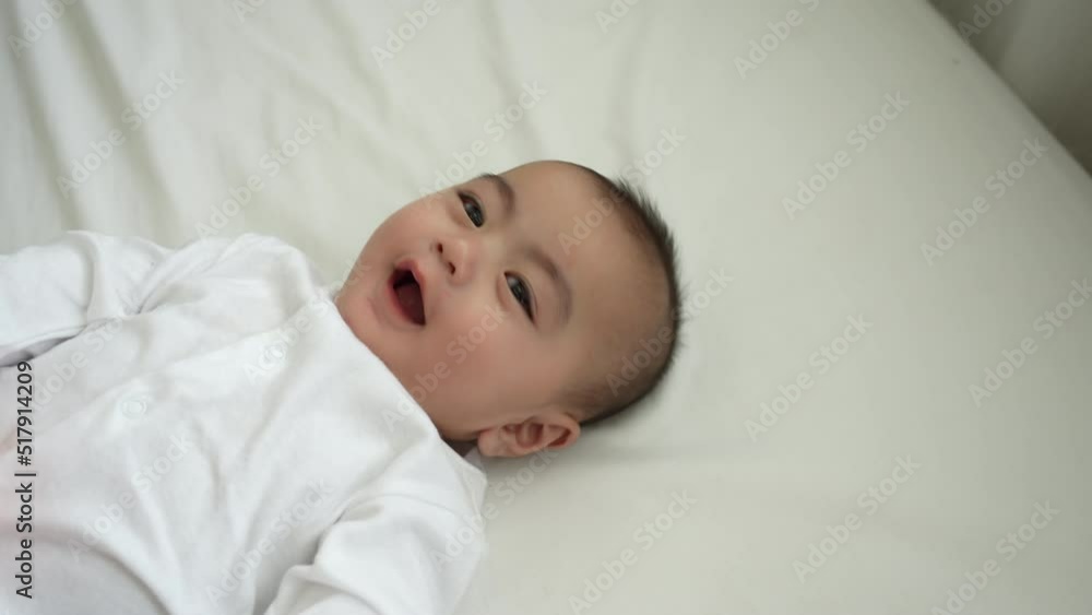 Smiling of newborn baby or cute little lying on a white bed at home. Infant child portrait happy concept, Healthy childcare in the morning. Smiling of newborn baby or cute little lying on a white bed at home. Infant child portrait happy concept, Healthy childcare in the morning.