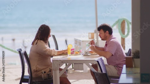 4K SlowMo - Delicious breakfast at a beach bar - watermelon, kiwi, orange, juice, coffe, jam, eggs, bacon- lovely couple having breakfast at beach bar in Conil, Cádiz, Spain