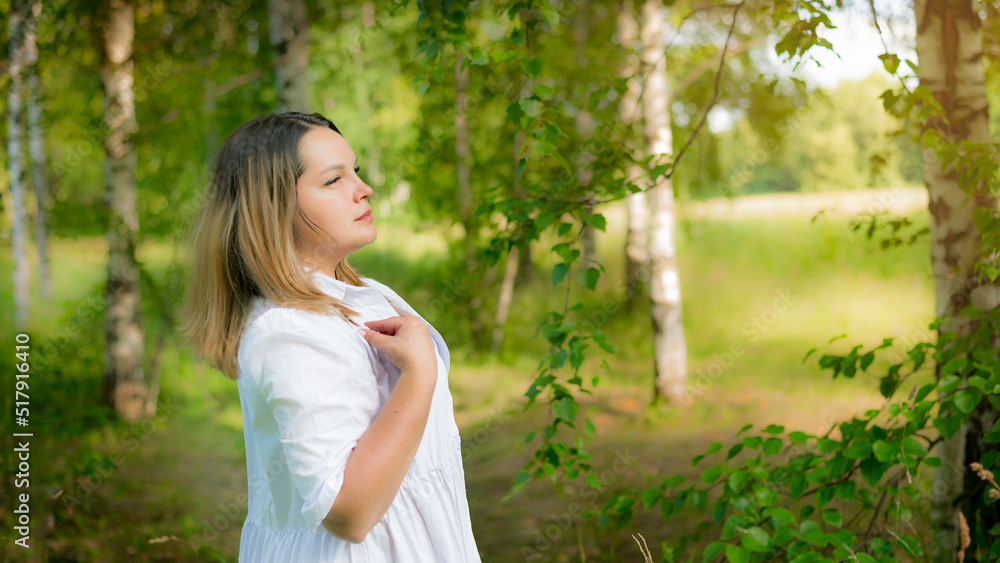 Photo of a cheerful happy young woman in the Spring mood park. The prospect of space Photo of a cheerful happy young woman in the Spring mood park. The prospect of space
