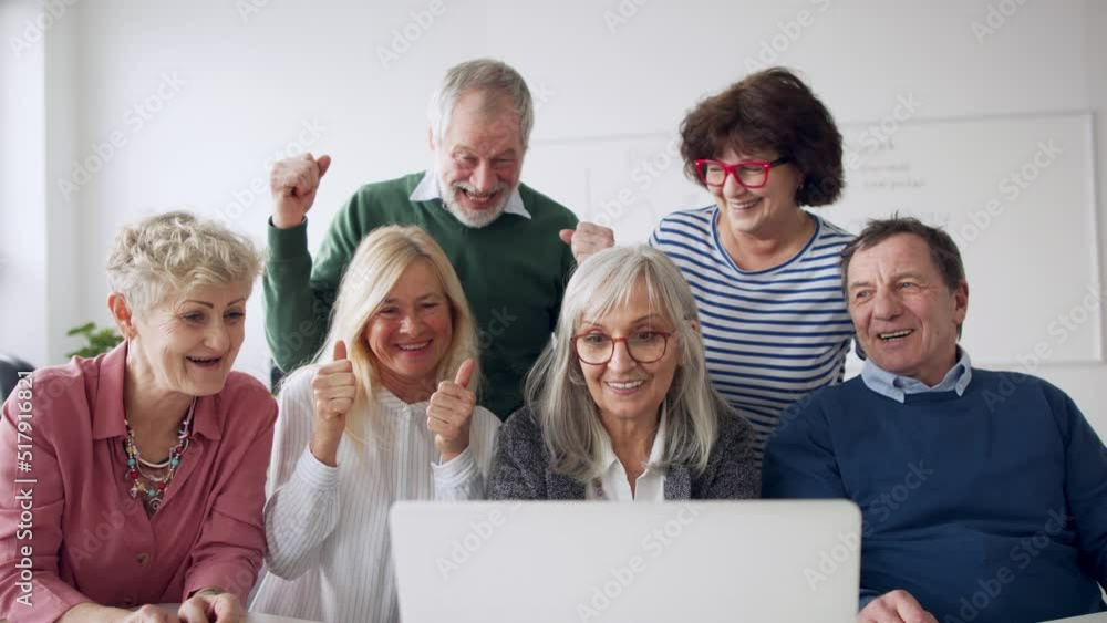 Group of cheerful seniors attending computer and technology education class. Group of cheerful seniors attending computer and technology education class.