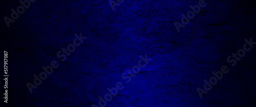 Blue abstract lava stone texture background, dark blue rough grainy stone or concrete wall texture background, Blue background with faint texture and bright center and black vignette border.