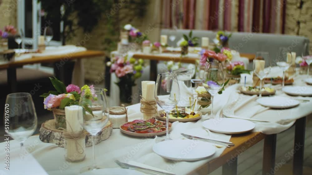 Beautiful wedding decor, all decorated in pink pastel colors, camera moving slow motion. Festive served plates on the table. Beautiful wedding decor, all decorated in pink pastel colors, camera moving slow motion. Festive served plates on the table.