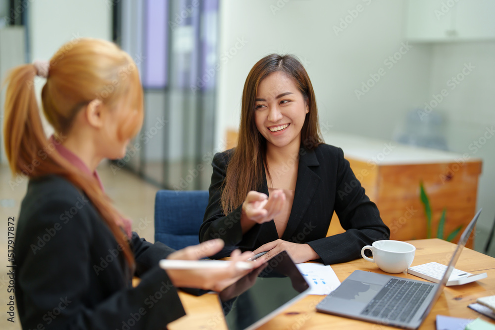 Fototapeta premium Portrait of an Asian businesswoman consulting, start up a marketing plan to meet the needs of customers in office room.