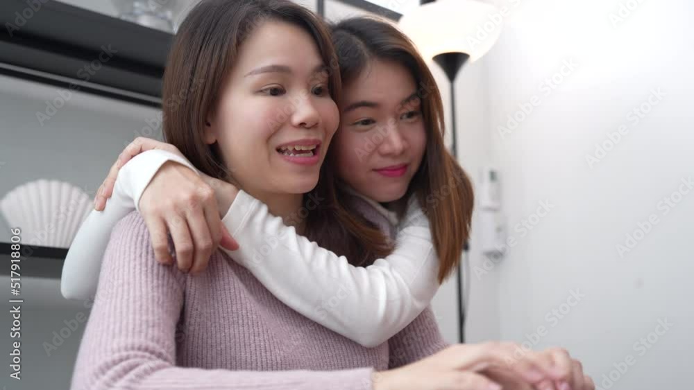 Asian lover family of mother and daughter using laptop computer together for shopping sitting on desk workplace hugging leisure love at home happiness insurance concept. Asian lover family of mother and daughter using laptop computer together for shopping sitting on desk workplace hugging leisure love at home happiness insurance concept.