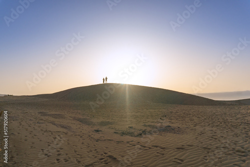 A couple enjoying the sunrise in the desert