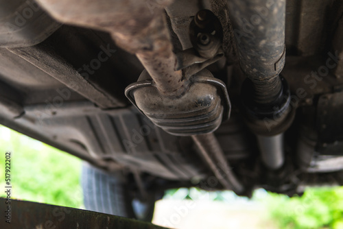 Close-up of Catalytic Converter in Car Exhaust System. The concept of preserving ecology, reducing harmful emissions into the air. legal regulations for vehicles with internal combustion engines