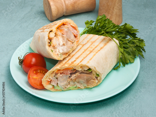 shawarma with chicken and vegetables on a blue background