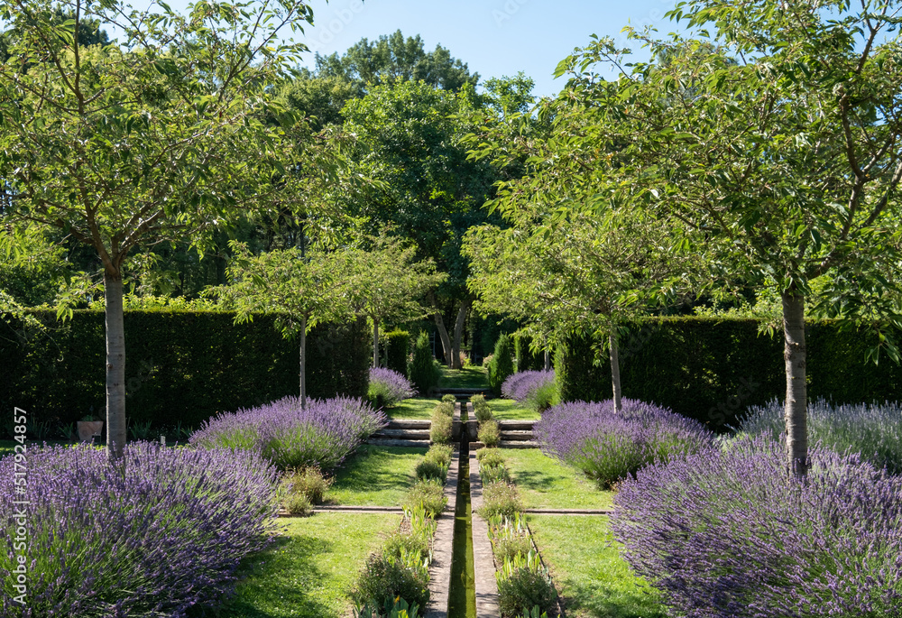 Landscaped garden with lavender and flowing water at Jardin Domaine de Poulaines in the Loire Valley, France. Landscaped garden with lavender and flowing water at Jardin Domaine de Poulaines in the Loire Valley, France.