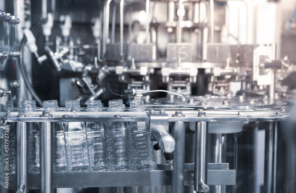 Process of water bottling plant. Plastic bottle on conveyor belt in beverage factory.