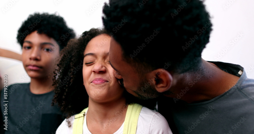 Family love, older brother kissing sister on cheek Family love, older brother kissing sister on cheek