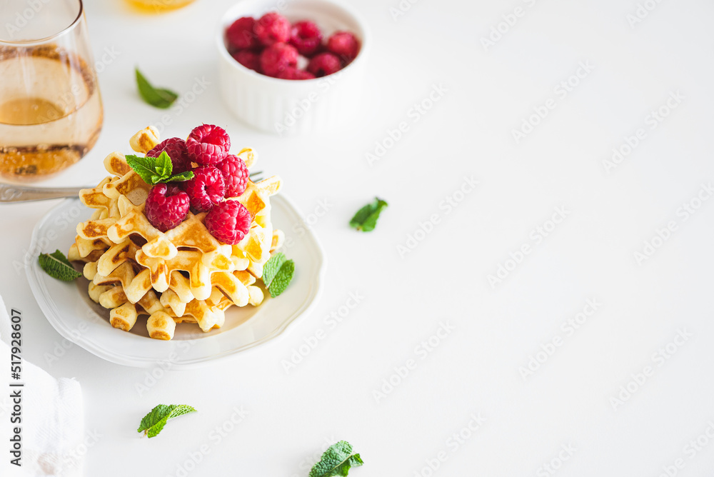 Homemade baked Belgian ricotta waffles with fresh berries on white wooden table Homemade baked Belgian ricotta waffles with fresh berries on white wooden table