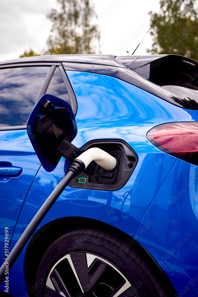 Charging Cable Attached To Environmentally Friendly Zero Emission Electric Car Outdoors