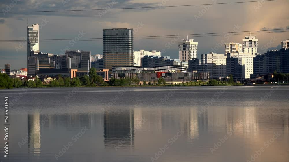 General view of the big city. Stylish modern skyscrapers are reflected in the mirror surface of a large pond. General view of the big city. Stylish modern skyscrapers are reflected in the mirror surface of a large pond.
