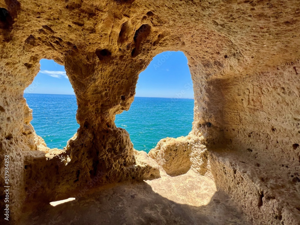 The Doll (A Boneca), the most famous viewpoint of Carvoeiro, two eroded archs with views out over the deep blues of the ocean. The natural caves exists in Algar Seco, Algarve - Portugal