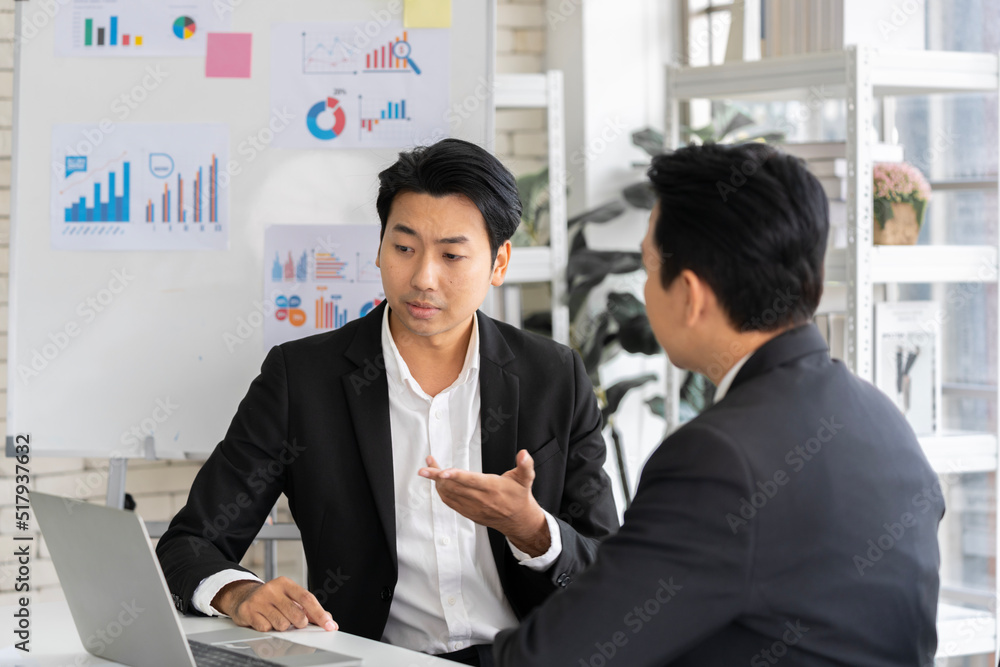 A group of young Asian businessmen Talking and planning work happily and have fun. at the company's office A group of young Asian businessmen Talking and planning work happily and have fun. at the company's office