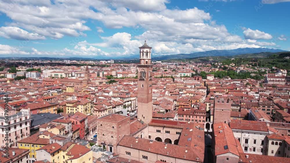 Aerial View of Torre dei Lamberti Medieval Tower, Center of Verona Old Town, Italy. Landmark and Buildings on Sunny Summer Day, Orbot Drone Shot Aerial View of Torre dei Lamberti Medieval Tower, Center of Verona Old Town, Italy. Landmark and Buildings on Sunny Summer Day, Orbot Drone Shot