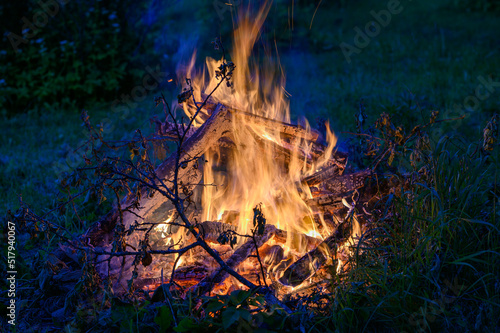 Burning apple tree branches in the fire. The custom of making a bonfire on spring holidays.