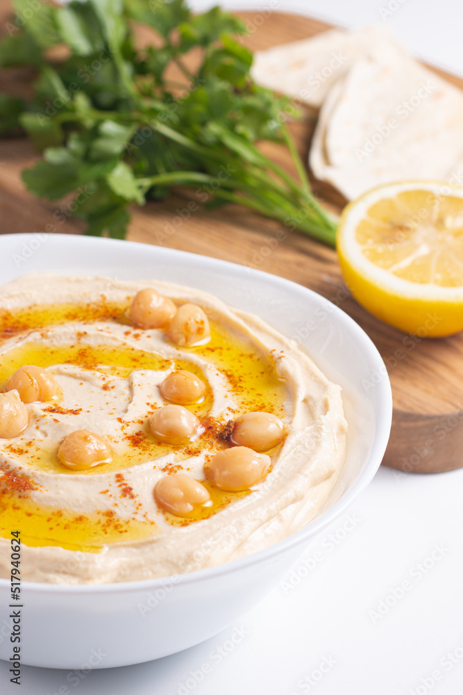 Delicious hummus with chickpeas, olive oil, lemon and pita bread. Vegetarian food concept. Delicious hummus with chickpeas, olive oil, lemon and pita bread. Vegetarian food concept.