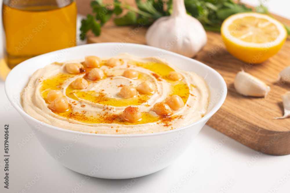 Delicious hummus with chickpeas, olive oil, lemon and pita bread. Vegetarian food concept. Delicious hummus with chickpeas, olive oil, lemon and pita bread. Vegetarian food concept.